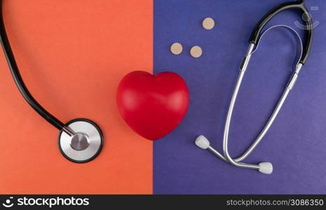 Toy heart and stethoscope on a colored background. Top view. Concept healthcare. Cardiology - care of the heart. cardiology, heart care