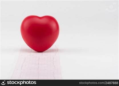 Toy heart on electrocardiogram background. Concept healthcare. Cardiology - care of the heart. cardiology, heart care