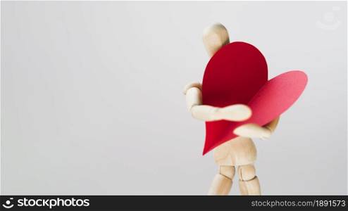 toy manequin holding heart with copy space. Resolution and high quality beautiful photo. toy manequin holding heart with copy space. High quality and resolution beautiful photo concept