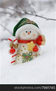 Toy of the snowman in snow