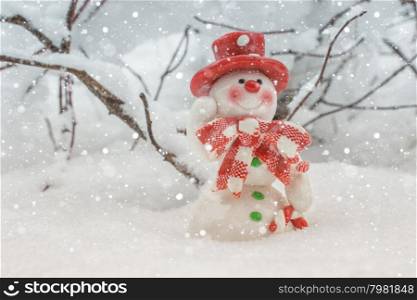 Toy of the snowman in snow