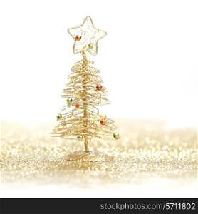 Toy small Christmas tree with decoration on white background