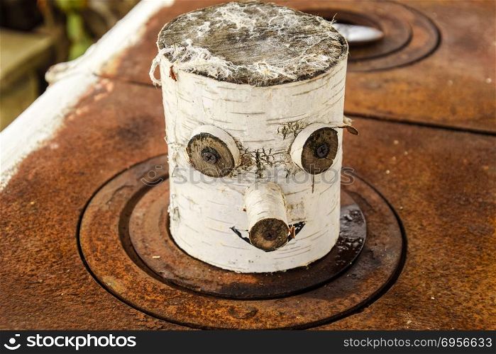 Toy souvenir from a birch log. eyes nose and mouth are made on a birch log.. Toy souvenir from a birch log. eyes nose and mouth are made on a birch log