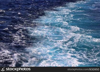 Trace from the motor of a marine vessel on the surface of the sea, beautiful nature background