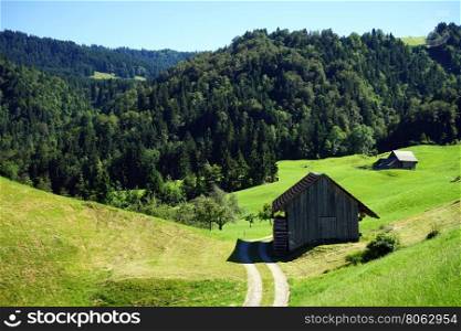 Track and wooden shed in mountain area of Switzerland