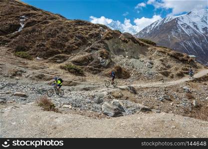 Track around Annapurna, Nepal-06.04.2018  Cyclists from New Zealand on the mountain trail 6 April 2018 on the track around Annapurna, Nepal. 