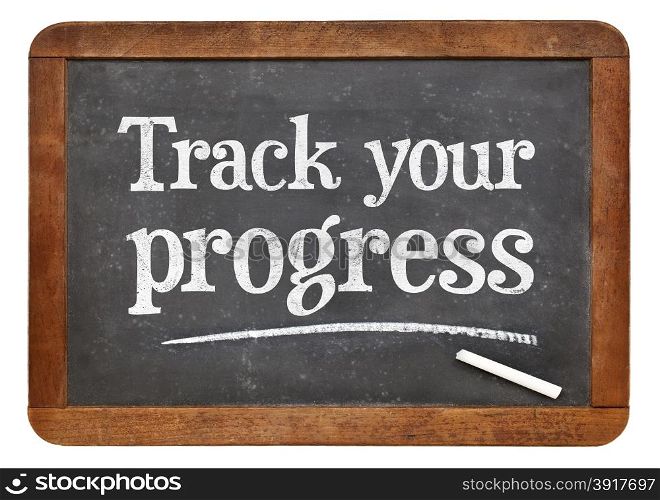 Track your progress advice - white chalk text on a vintage slate blackboard