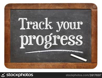 Track your progress advice - white chalk text on a vintage slate blackboard