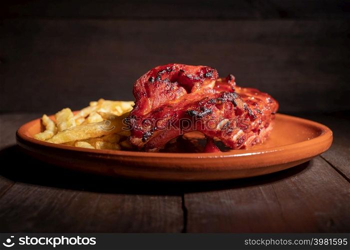 Tracking shot of delicious Grilled bbq ribs on stone plate. High quality photography.. Tracking shot of delicious Grilled bbq ribs on stone plate.
