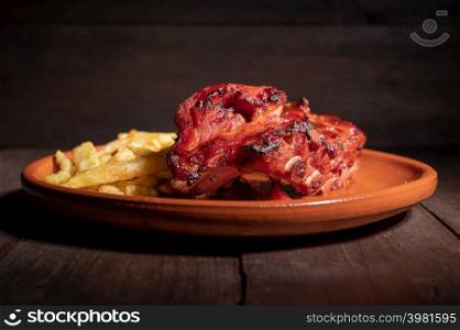 Tracking shot of delicious Grilled bbq ribs on stone plate. High quality photography.. Tracking shot of delicious Grilled bbq ribs on stone plate.