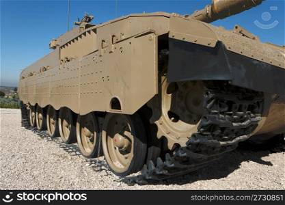 Tracks and wheels closeup of new Israeli tank in museum