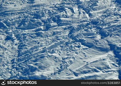 Tracks of skiers and snowboarders in powder snow