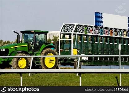 Tractor and empty starting gates at the horseracing track