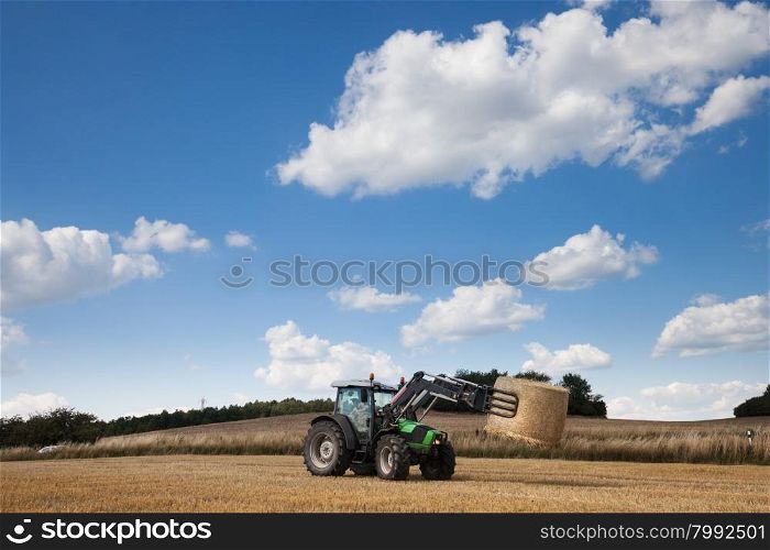Tractor carrying hay at the field