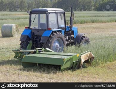 Tractor in a field, agricultural scene in summer