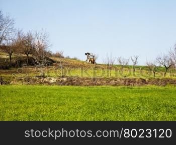 Tractor in the country landscape, horizontal image