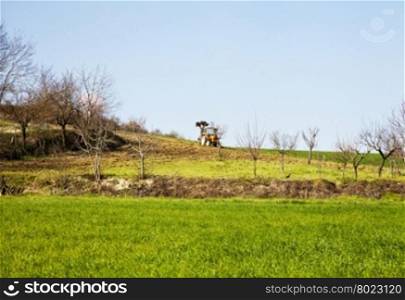 Tractor in the country landscape, horizontal image