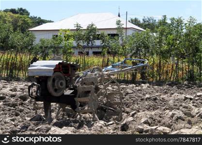 Tractor on the plough field in Indonesia