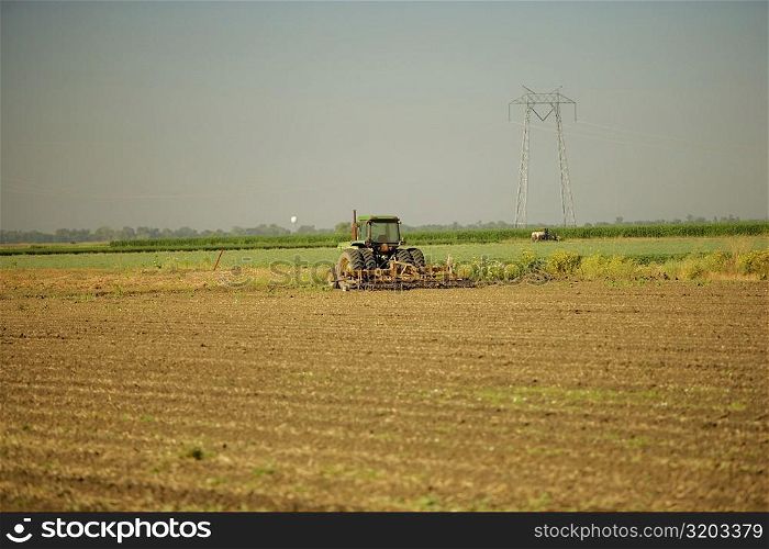 Tractor plowing a farm