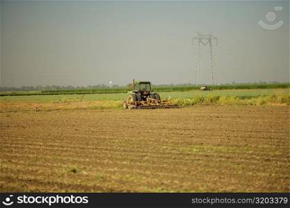 Tractor plowing a farm