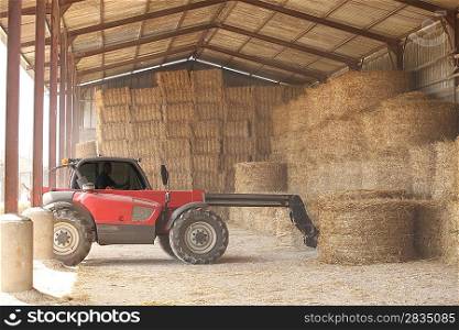 Tractor storing bails of hay