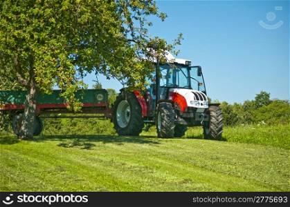 tractor under apple tree