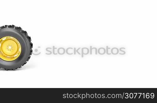 Tractor wheel rolling from left to right