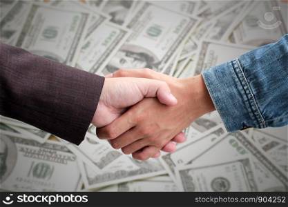Trade agreements business people or companies. businessman handshake dealing with Banknote background.