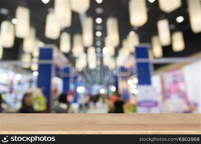 trade fair in exhibition hall, booth selling cheap goods from the manufacturer with selected focus wood table for display your product