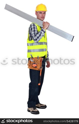 Tradesman carrying a girder