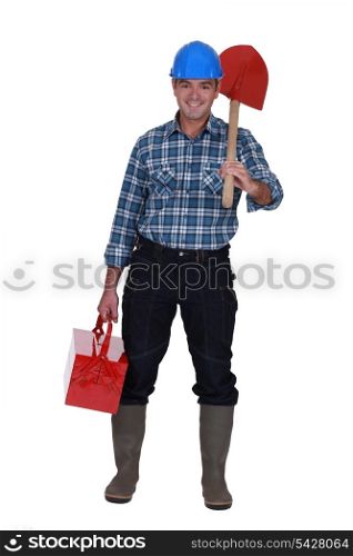 Tradesman carrying a spade and a toolbox