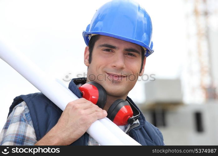 Tradesman carrying blueprints