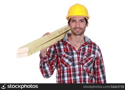 Tradesman carrying wooden planks