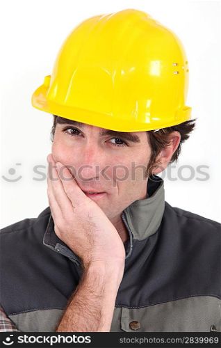 Tradesman covering his mouth