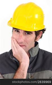 Tradesman covering his mouth