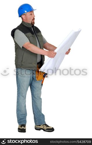 Tradesman examining a blueprint