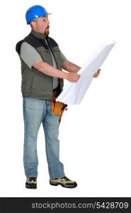 Tradesman examining a blueprint