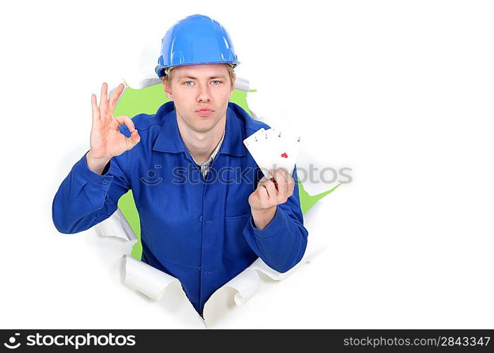 Tradesman giving the a-ok sign and holding up cards
