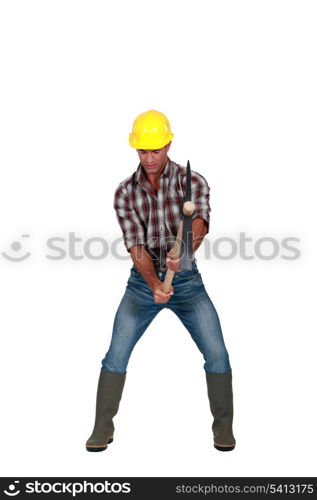 Tradesman hacking the ground