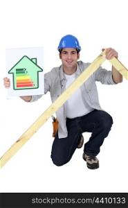 Tradesman holding a frame and an energy efficiency rating chart