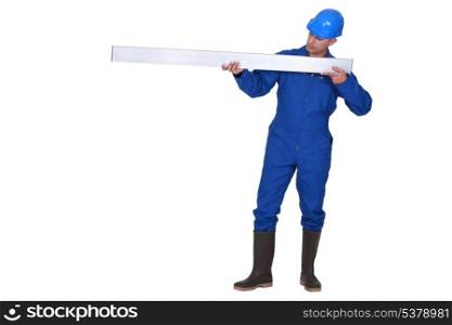 Tradesman holding a girder