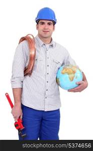 Tradesman holding a globe, a coiled copper wire and a pipe wrench