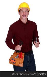 Tradesman holding a pair of pliers and a cable