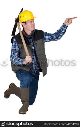 Tradesman holding a pickaxe and pointing his finger