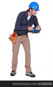 Tradesman holding a sander