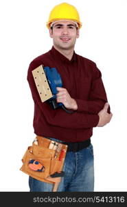 Tradesman holding a sander