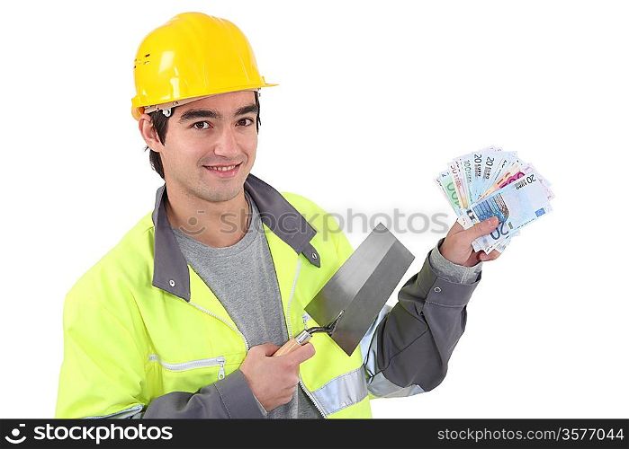 Tradesman holding a trowel and cash