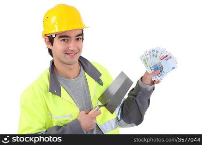 Tradesman holding a trowel and cash