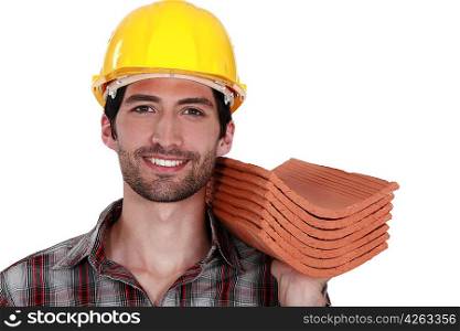 Tradesman holding shingles