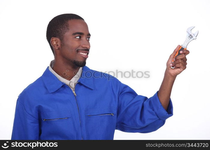 tradesman holding spanner,